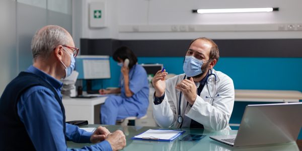 Retired man and physician talking about health care medicine