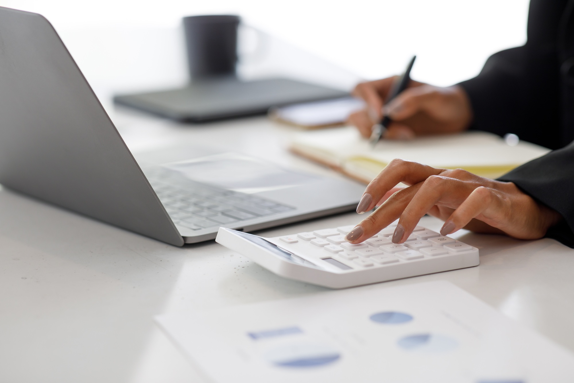 close-up-of-businesswoman-accounting-using-calculating-income-expenditure-and-analyzing-real-estate-1.jpg